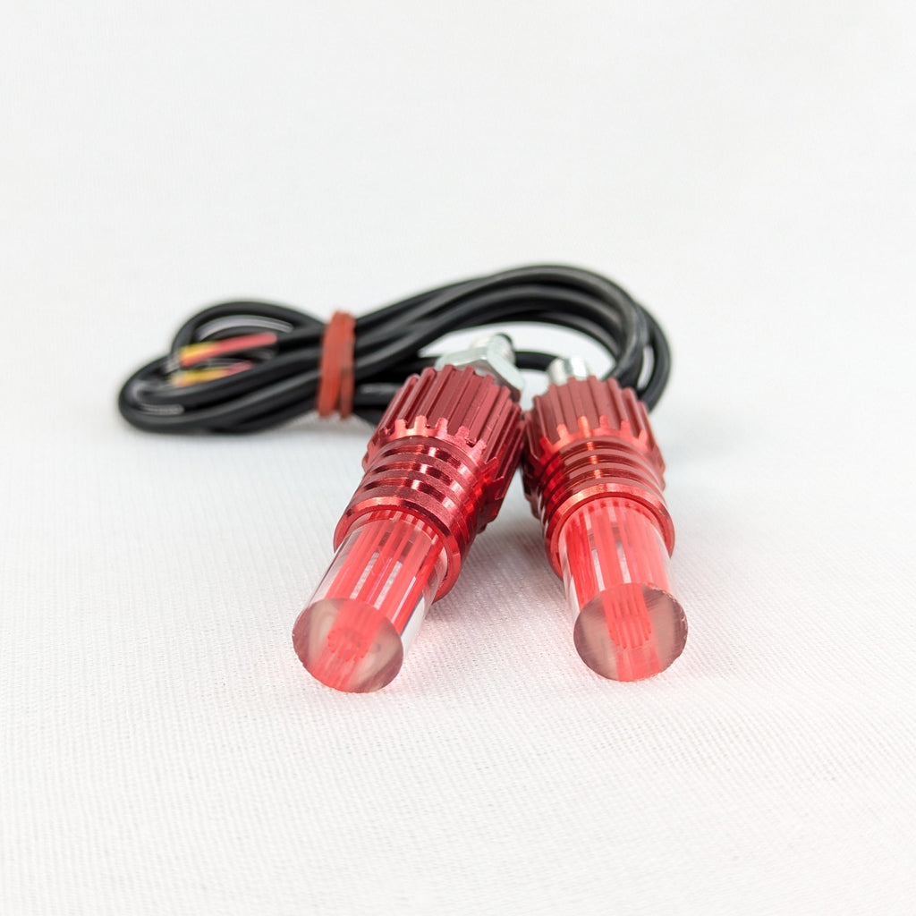 Two red LED lights with a cable on a white background