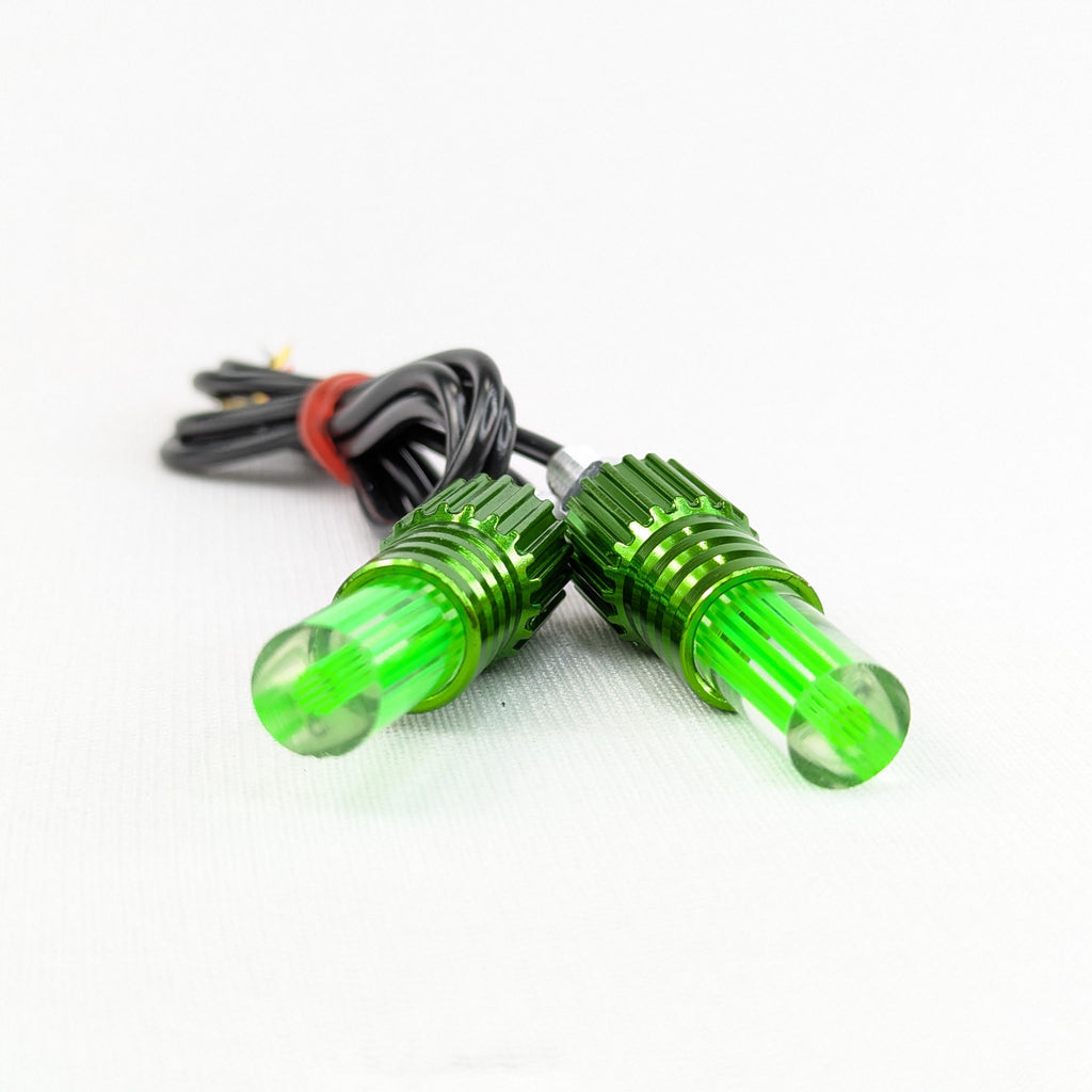 Two green LED lights with wiring on a white background