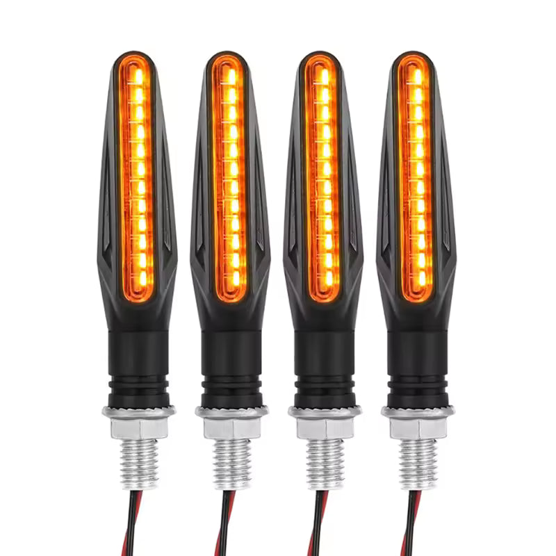 Four amber LED turn signals with black casings on a white background