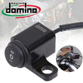Motorcycle ignition switch with Domino Racing logo on a blurred background