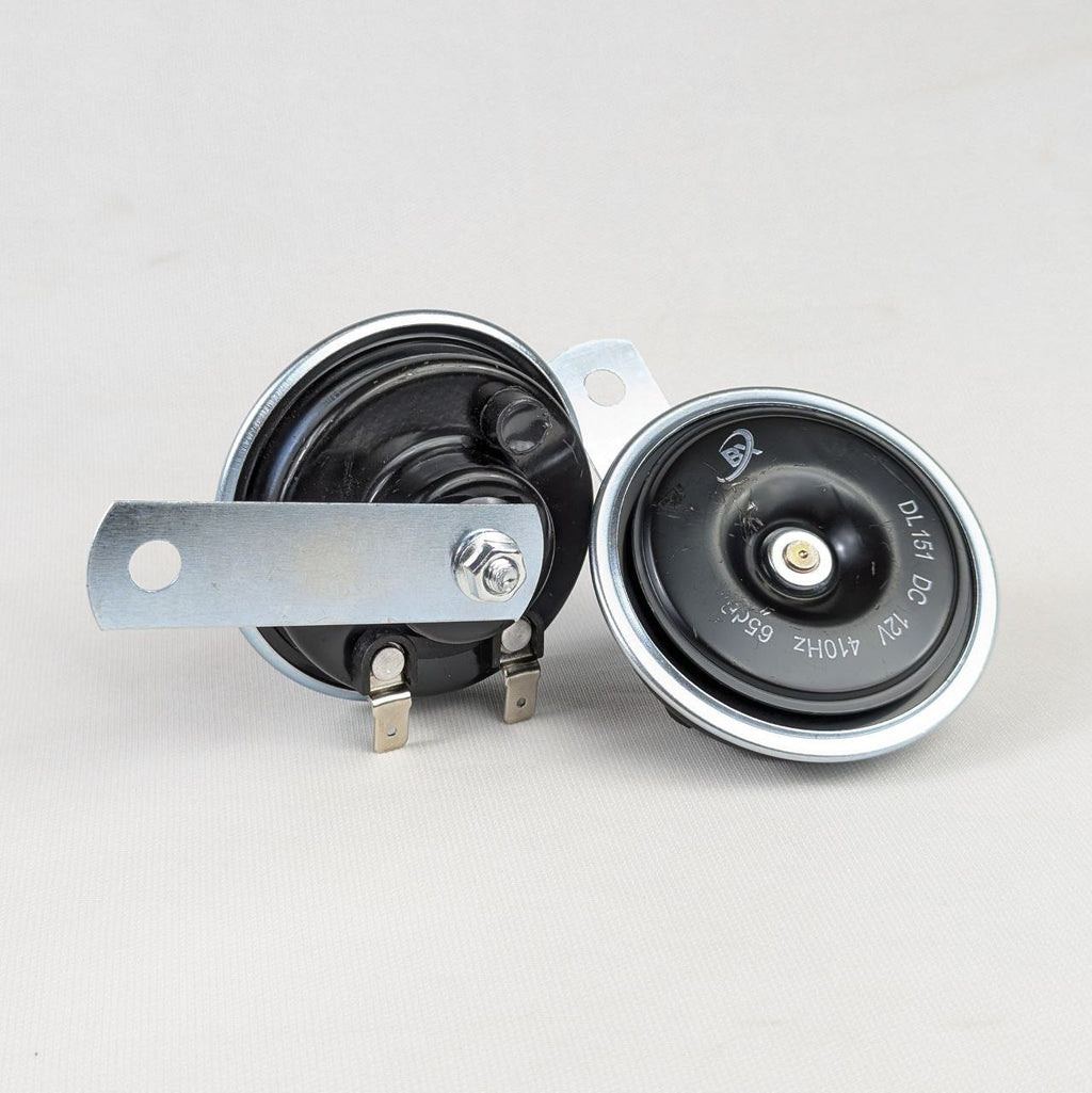 Two black and silver electrical components on a light gray background