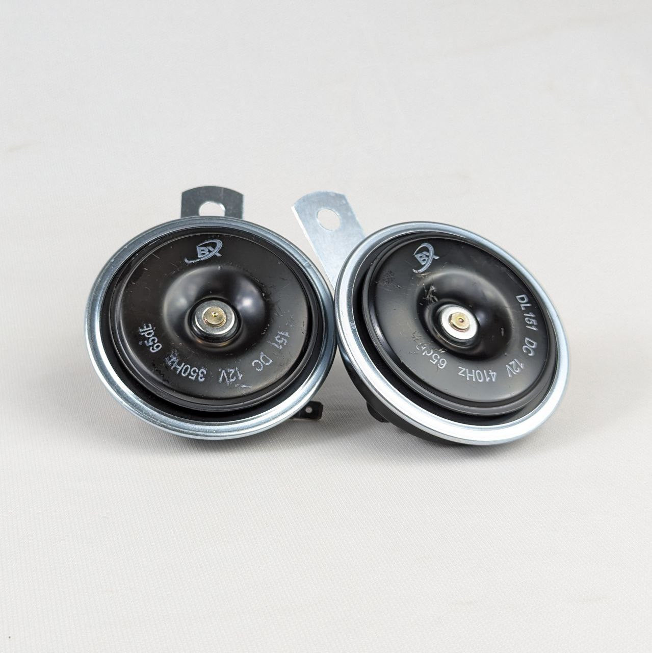 Two car speakers on a white background