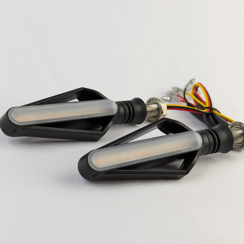 Two motorcycle turn signals on a white background