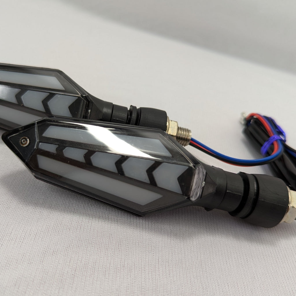 Motorcycle turn signal mirror with wiring on a gray background