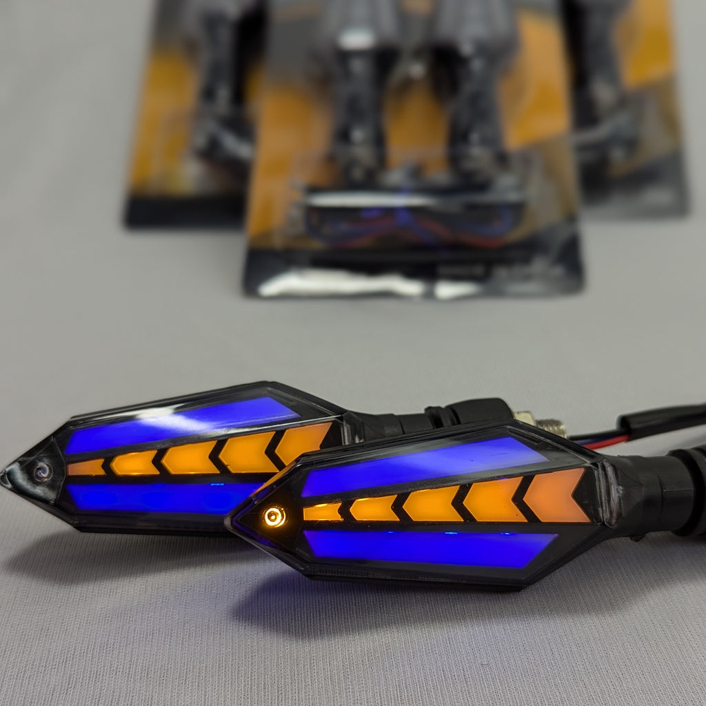 Motorcycle turn signals with blue and orange design on a gray surface