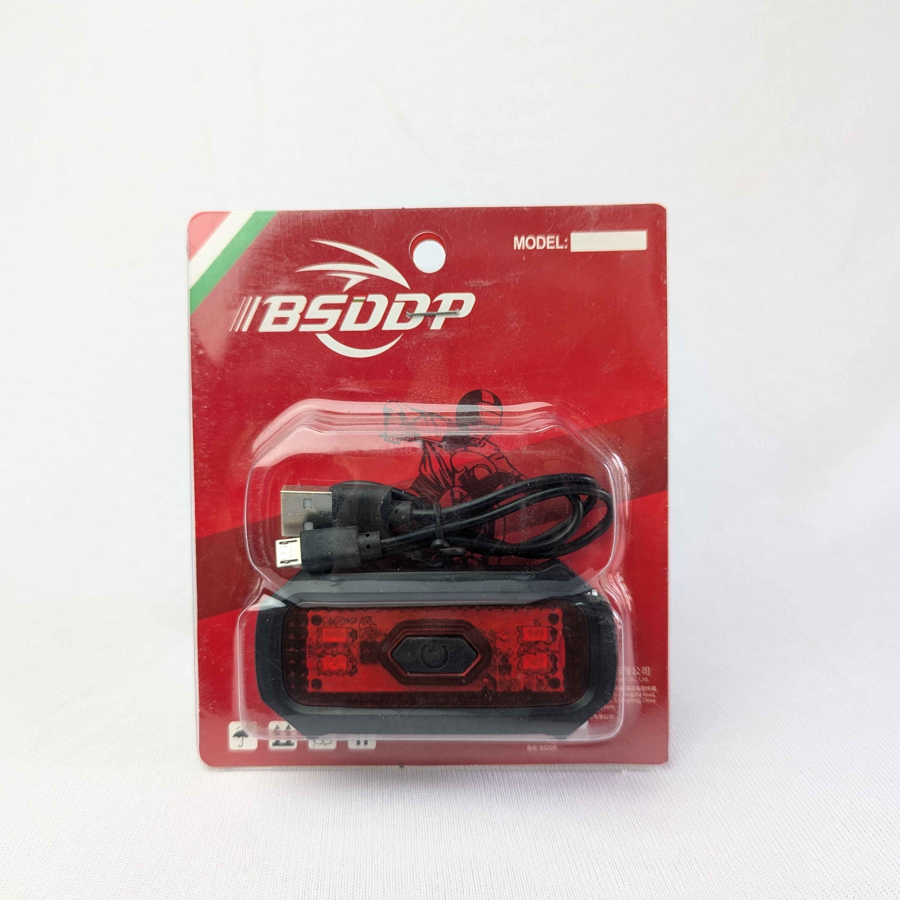 Bicycle light with USB cable in BSDCP packaging on a white background
