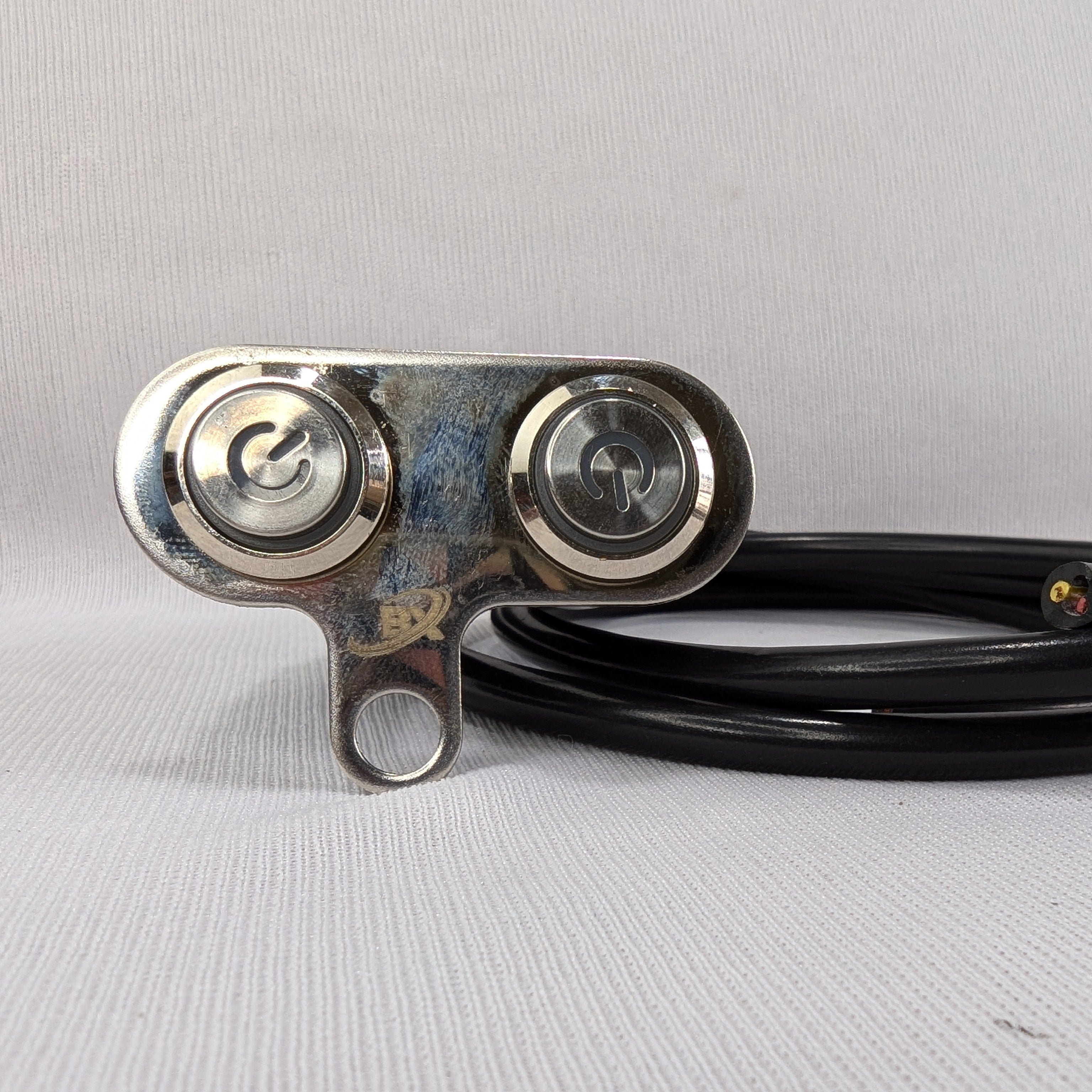 Metallic pulley system with black belt on a gray background
