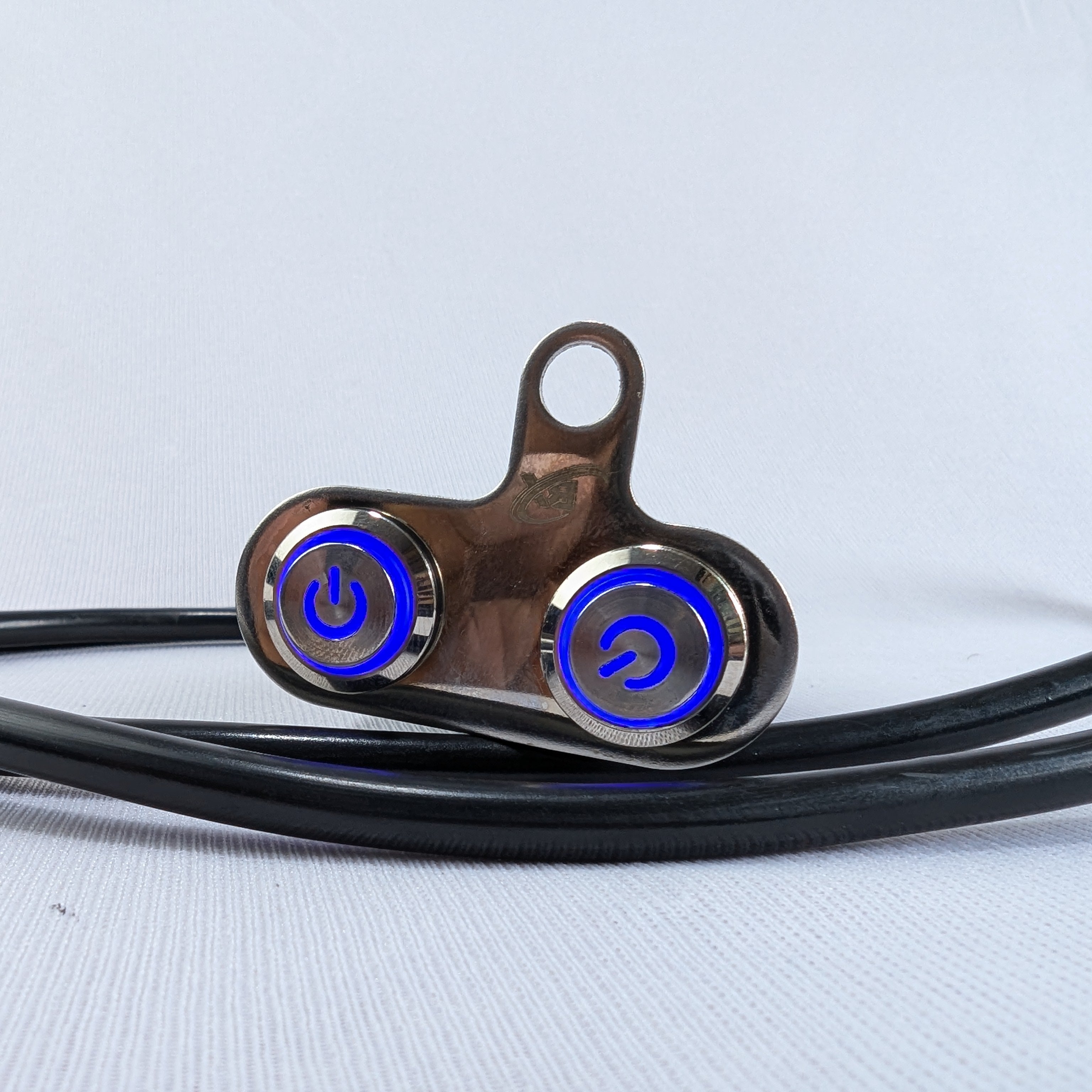 Close-up of a metallic device with blue lights on a light gray background