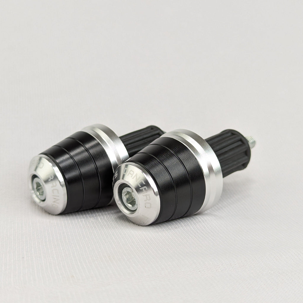 Two black and silver cylindrical objects on a light gray background