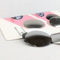 Black adhesive patches on a white card with pink border