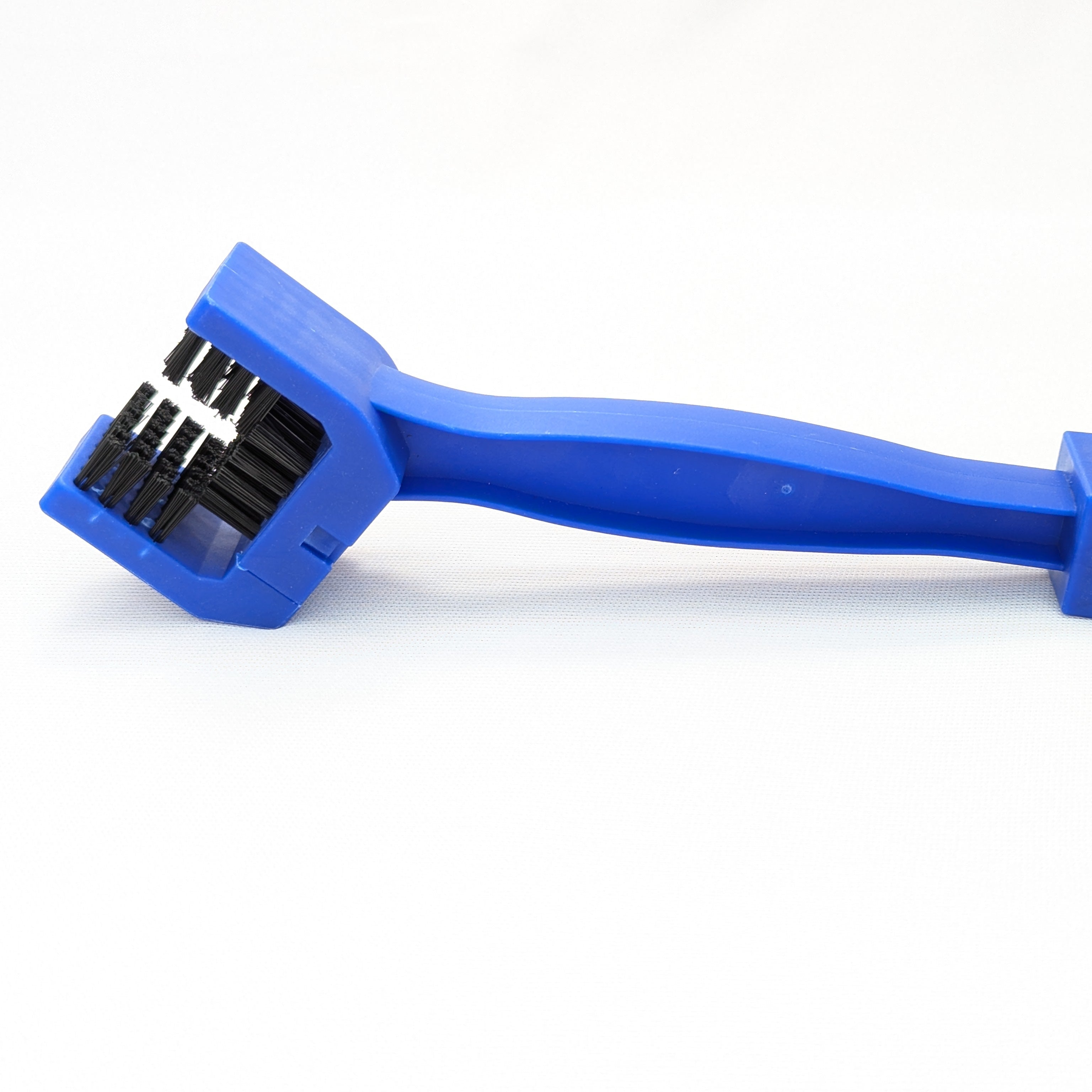 Blue brush with black bristles on a white background