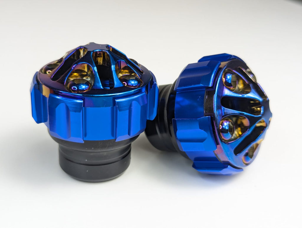 Two blue metal knobs on a white background